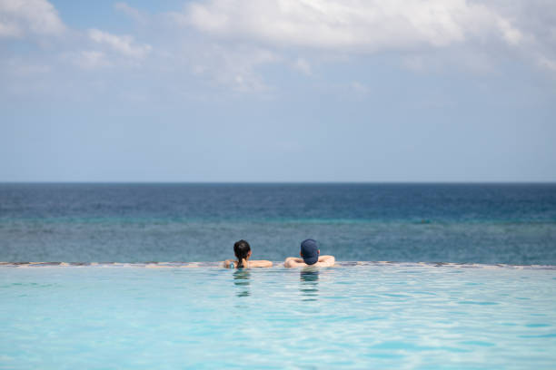 father and daughter playing in the pool