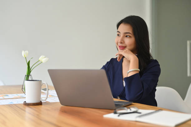 istock Work space with Millennial Young Asian businesswoman thinking new idea while looking away. 2055653315