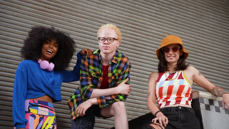 Portrait of smiling young friends on ramp at skate park