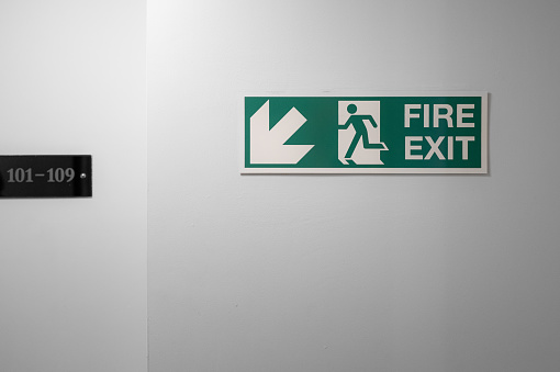 Close-up of an illuminated fire exit sign.