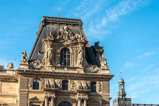 Detail of the left wing facade of Louvre Palace on a sunny summer day in Paris, France