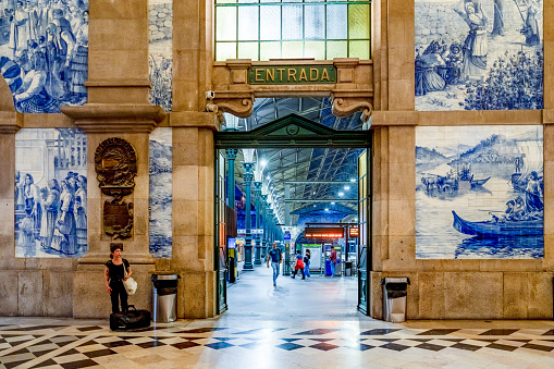 Porto, Portugal - October 5, 2023: The classic interior of the Sao Bento train station and people in Porto, Portugal.