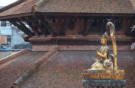 Real art masterpiece in old temple - statue of Yoga Narendra Malla or Yoganarendra with cobra snake on Patan Durbar Square royal medieval palace and UNESCO World Heritage Site. Lalitpur, Nepal.