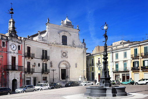 Popoli, Italy: the church of San Francesco, the civic tower with the clock and the fountain in the medieval Piazza della Libertà, main square of the town in Pescara province, Abruzzo, in Italy