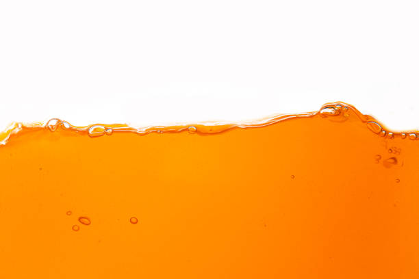 istock Orange juice isolated white background,orange juice texture on white background,Close up bright orange juice texture for health and nature waves 2055731700