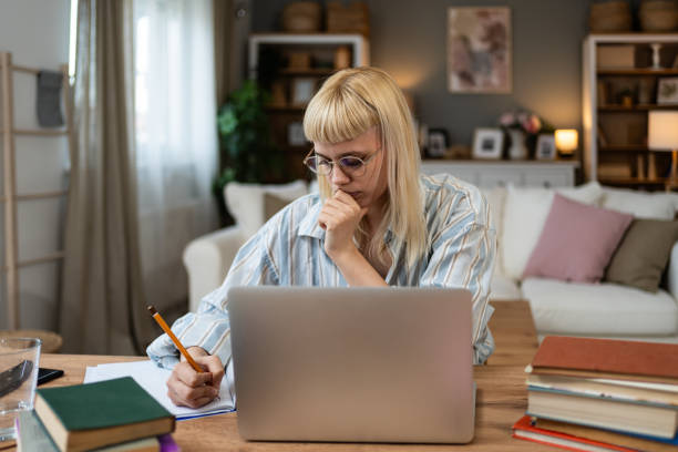istock Side hustle money, second job concept. Young university student woman working freelance internet online job to pay student loan, saving money for rent, travel vacation Female work from home video call 2055794472