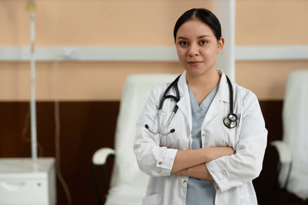 istock Medic Wearing Lab Coat Looking at Camera in Clinic 2055817194