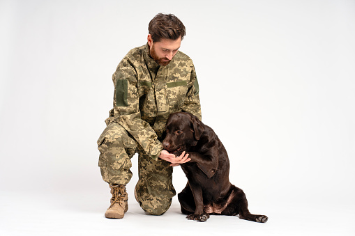 Army soldier loving his trained dog