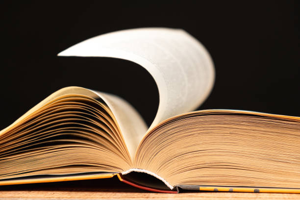 istock Pages of a thick book are turned on a black background. 2055824721