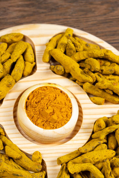 istock Turmeric powder and dried turmeric root top view. 2055825238