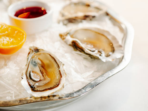 istock Woman having oysters at table 2055827312
