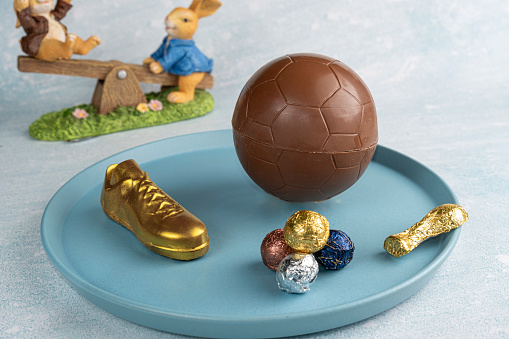 Belgian chocolate Easter egg shaped like a soccer ball. Stuffed with small milk chocolate balls and trophies.