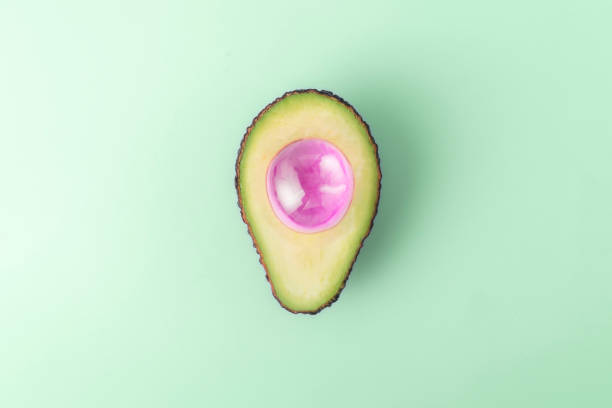 istock Creative diet concept. Cut avocado with air bubble on blue pastel background with copy space. 2055844166