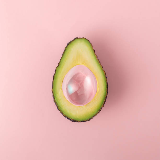 istock Creative diet concept. Cut avocado with air bubble on pink background. 2055844174