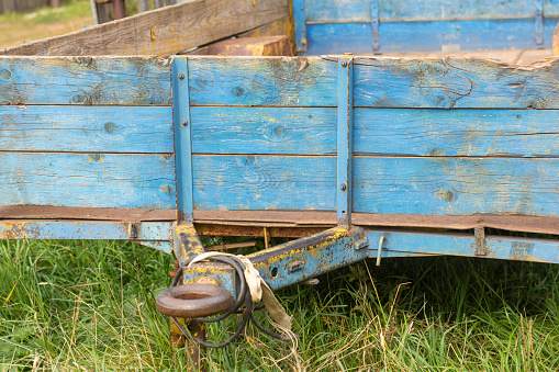 An old rusty cargo trailer stands still