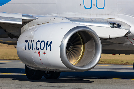 Salzburg, Austria - January 27, 2024: Logo of travel company TUI on the CFM56 engine of a Boeing 737 charter airplane