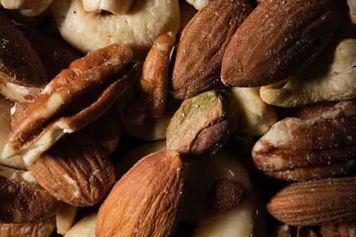 Nuts placed on a plate on a white background