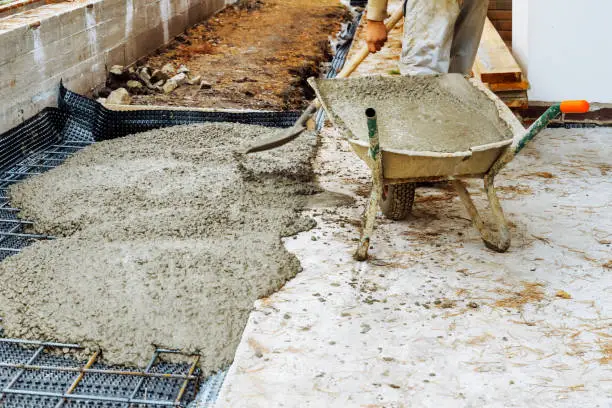 Photo of Cementing garden paths on top of metal mesh, construction work in the garden.