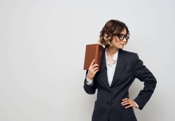istock Woman with documents in hands classic suit and glasses hairstyle 2055901369