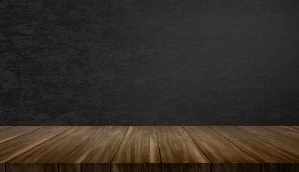 istock empty wood table at foreground with dark green color fabric wallpaper at background for product placement displayed. empty brown wooden deck table with green background for natural cocept. 2055922420