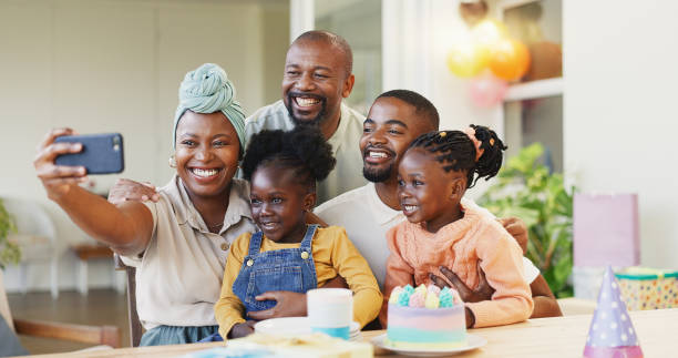 selfie, birthday party and children, family or parents on social media, online memory and celebration, smile and hug. african people, mother and dat, kids and cake in profile picture for holiday - cake birthday domestic kitchen child ストックフォトと画像