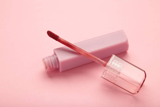 istock Lip gloss bottle on pink background. Macro photo 2055949255