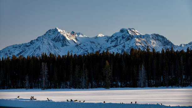 Last light of day illuminates high snow mountain peaks in Idaho