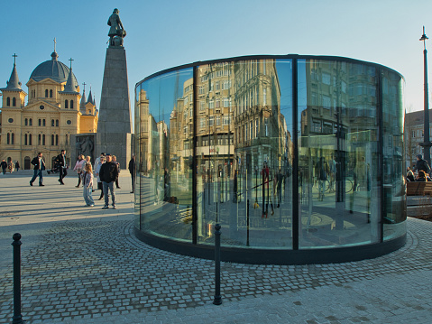 Residents of Lodz walk on a sunny day along the restored Freedom Square.