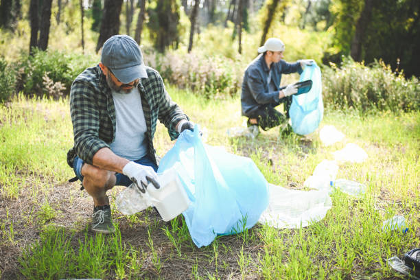 istock male volunteers collecting garbage in the forest 2055997865