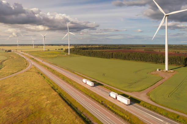 istock Trucks with trailers in a rural landscape with wind turbines 2056005085