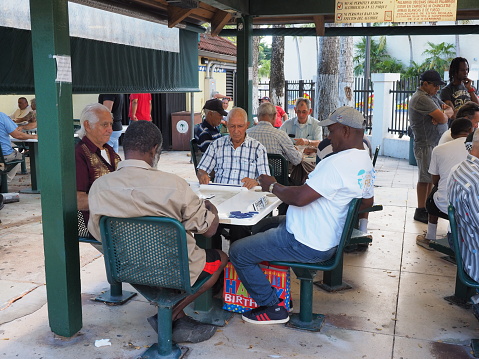 Miami, Florida 10-21-2018: Senior Cubans gather at Domino Park on Calle Ocho - Eighth Street - in Little Havana for a game of dominoes.