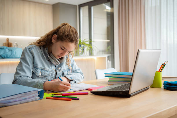 istock Teenage girl studying at home using laptop 2056043805