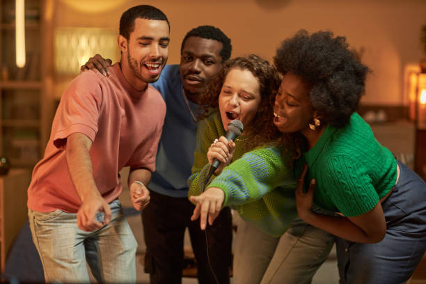 istock Diverse Group of Friends Singing to Microphone 2056048060