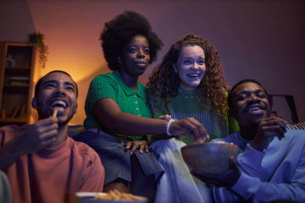 istock Group of excited young people watching TV 2056048303