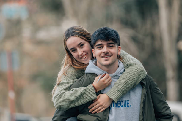 istock couple having fun with the girl on their backs 2056052261