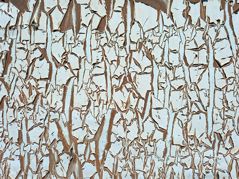 Abstract uncorked wall background. Rough texture. Peeling paint and rusty old metal background. Patterns and texture.