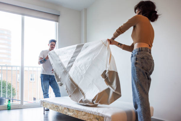 istock Young multiracial family making a new bed with fresh linen and mattress case 2056102607