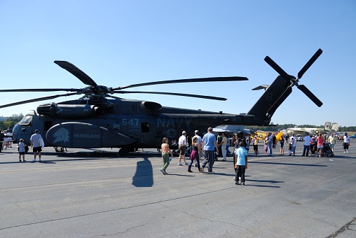 People view a large military helicopter at airshow Georgia, USA.