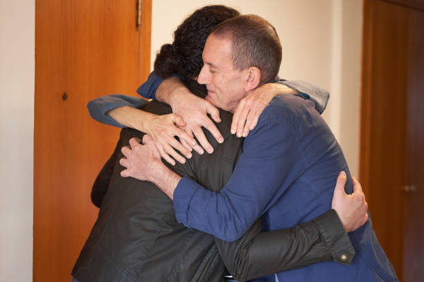 istock Son hugging  senior parents with love 2056118696