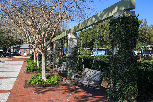 Beaufort, South Carolina, USA - 19 of February 2024: A few wood bench swings hanging in Henry Chambers Park for a great spot to relax in a beautiful park.
