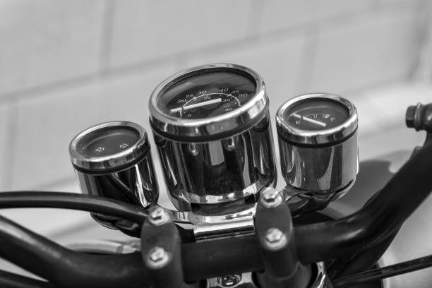 a speedometer from a motorcycle in black and white in selective focus