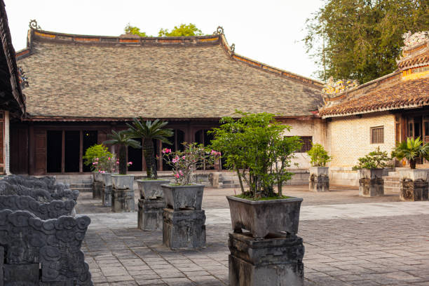 istock A serene courtyard showcases classical Vietnamese house, featuring an intricate window design, ornamental roof tiles, and potted plants, in the soft light of the setting sun in Hue city, Vietnam 2056153694