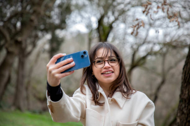 istock A beautiful woman taking a selfie in a public park 2056166063