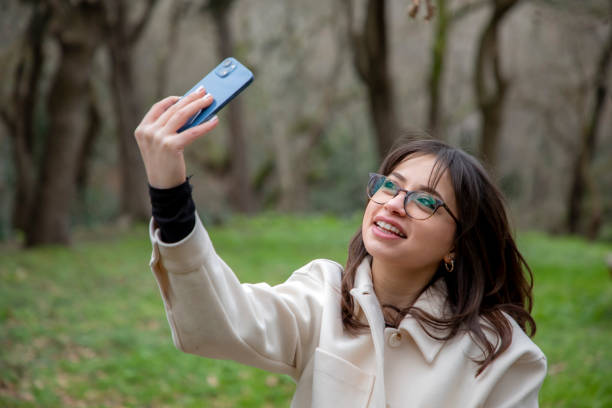 istock A beautiful woman taking a selfie in a public park 2056166066