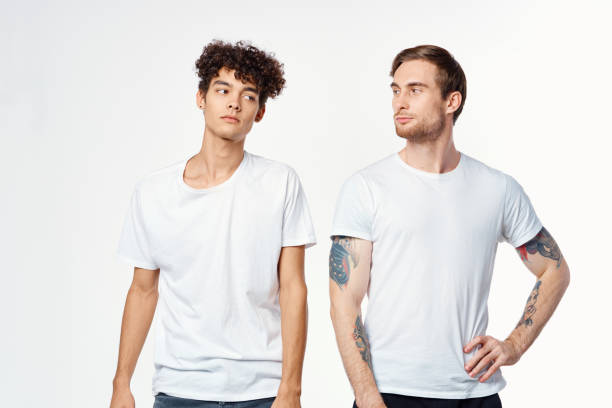 istock two men in white t-shirts stand side by side cropped view studio 2056198655