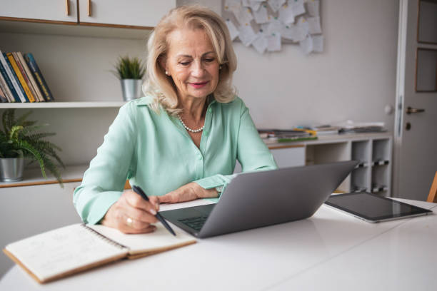 istock Senior woman taking notes during the meeting 2056198656