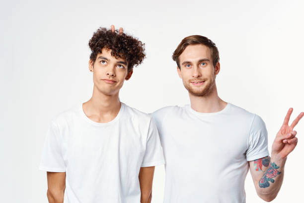 istock two men in white t-shirts gesturing with their hands Friendship Studio 2056202768