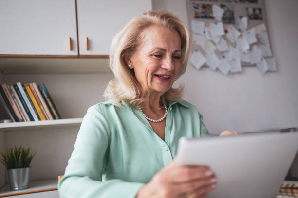 istock Senior woman using digital tablet for a business meeting 2056213734