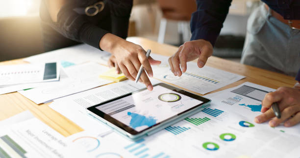 istock Business people, data analysis with tablet and documents, hands with online review in meeting and team with market research. Statistics, analytics dashboard and digital infographic with collaboration 2056252928
