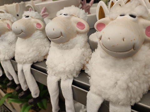 Fluffy sheep sitting in row home decoration